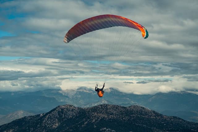 Red wing above mountain ridges