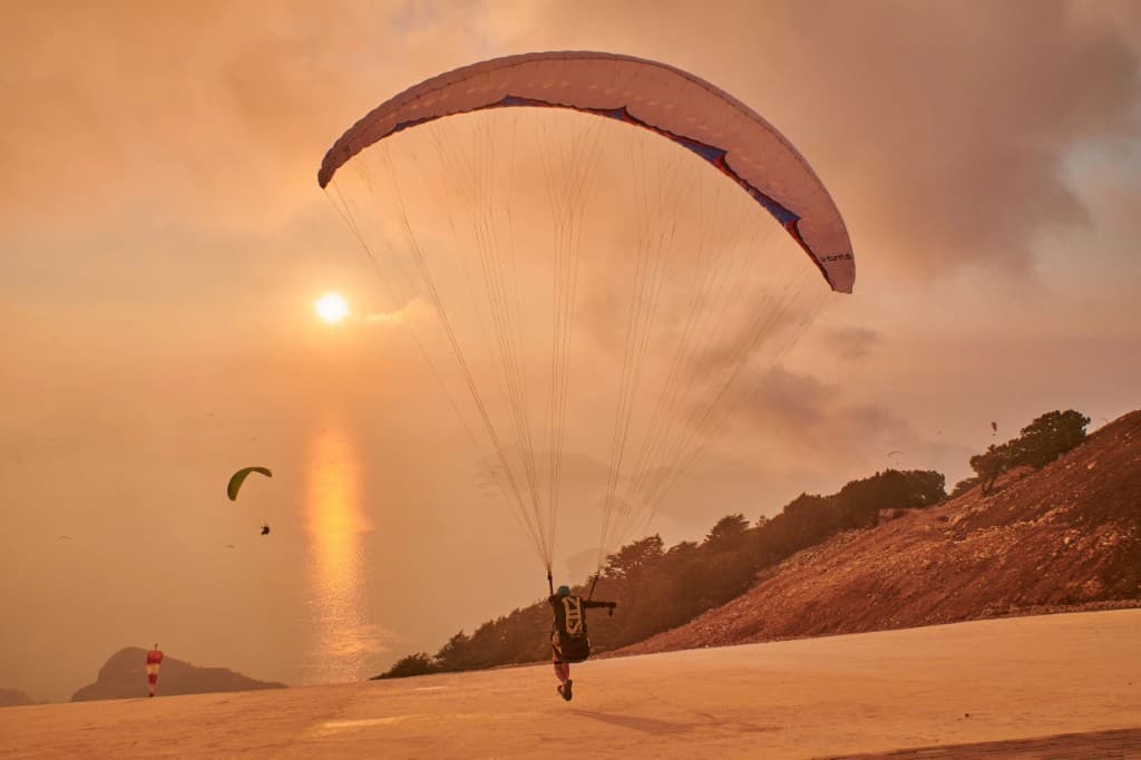 Pilot landing into a golden sunset over the sea
