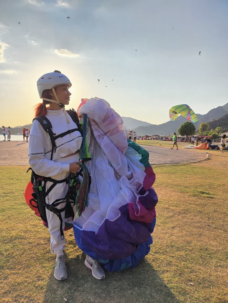 Pilot in white gear ready to fly at sunset