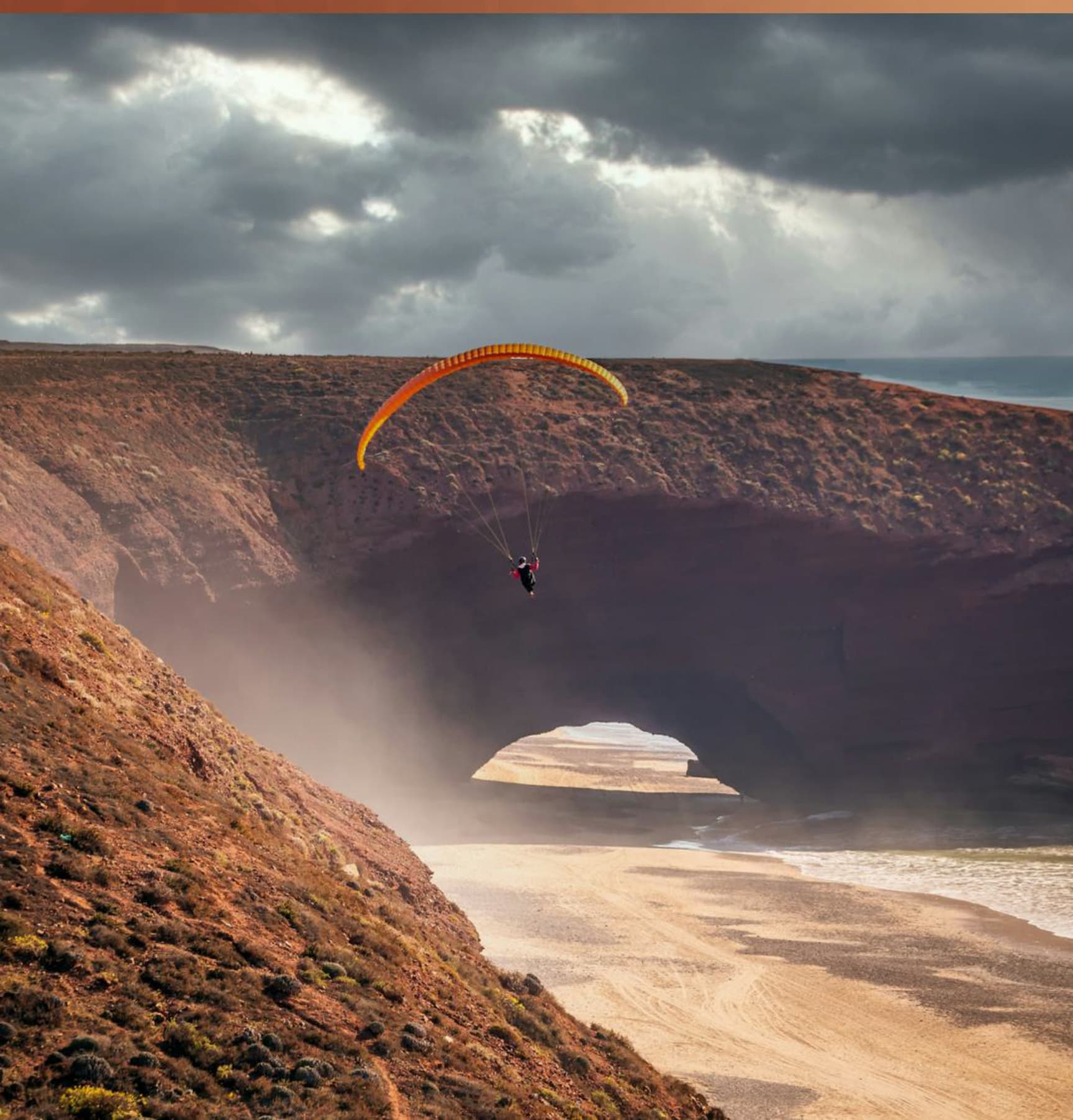 Paragliding over Legzira cliffs, Morocco